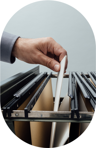 man placing file into filing cabinet